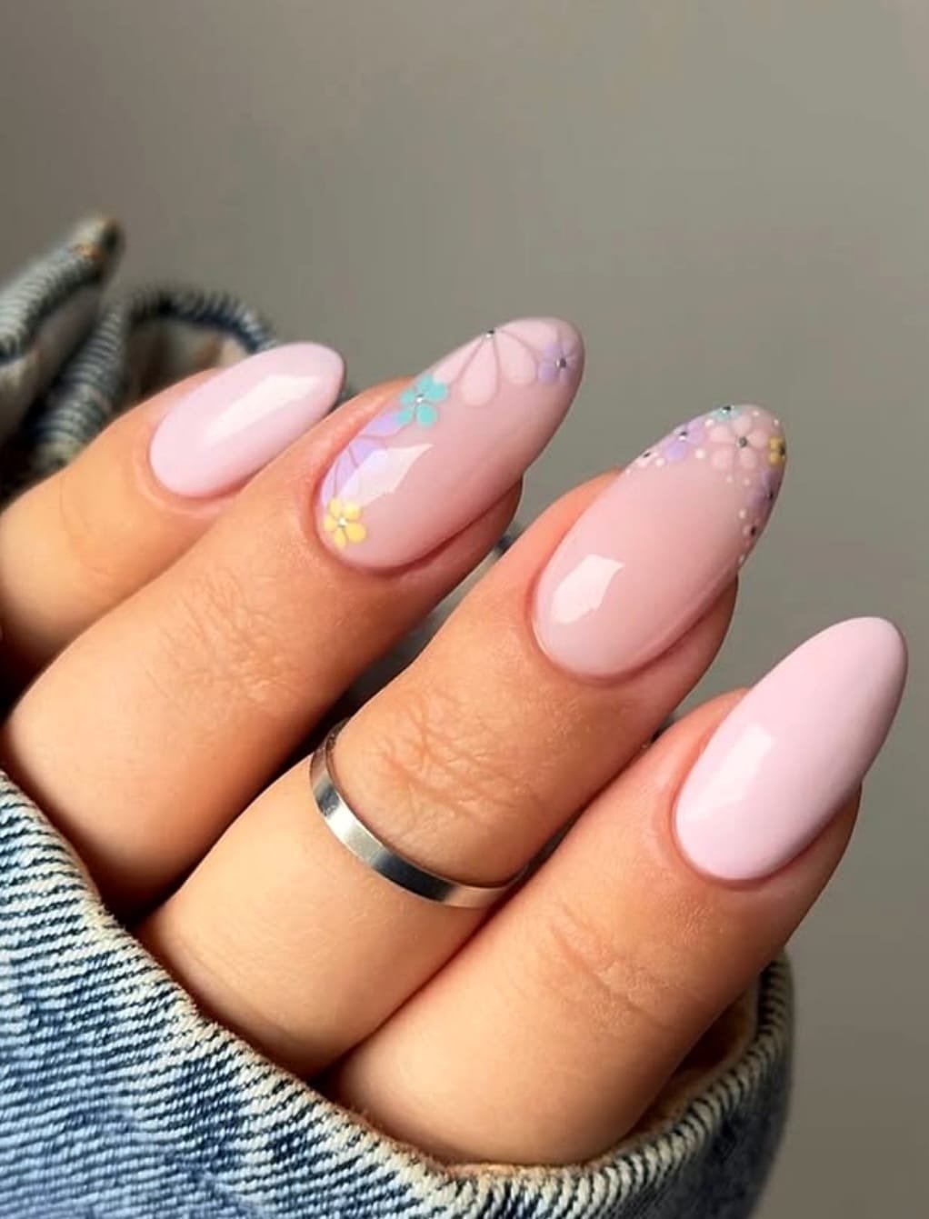Solid pink nails with delicate floral accents