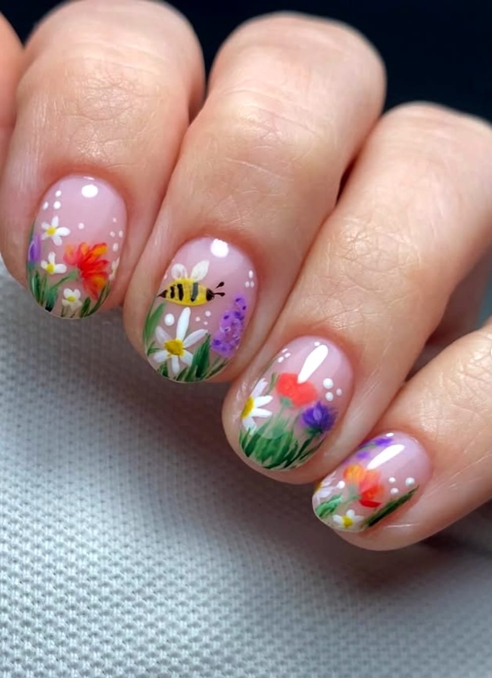 Hand-painted wildflowers, a bee and green grass